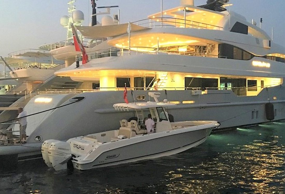 Boston Whaler 280 Outrage tender next to yacht